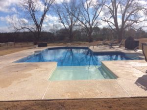 A custom finished in-ground pool with several different depths.